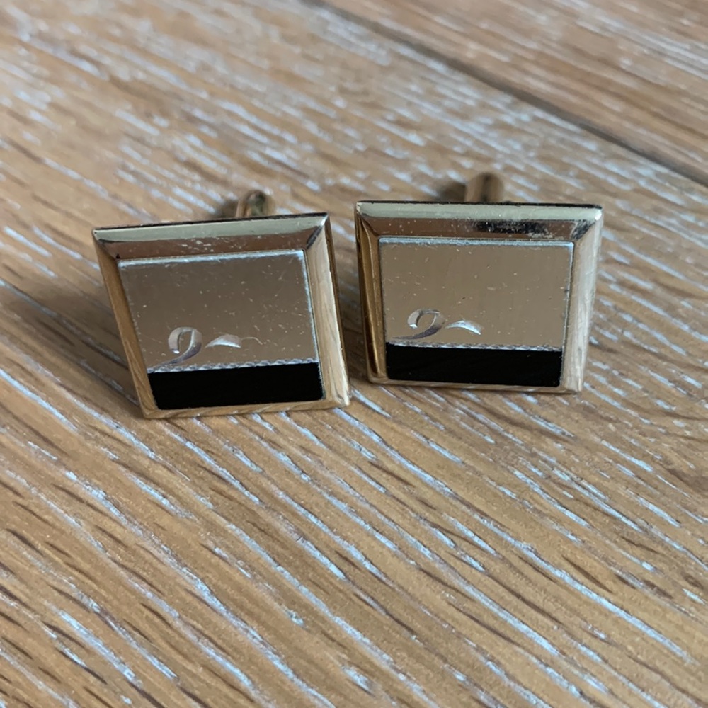 gold cuff links with silver and black accents